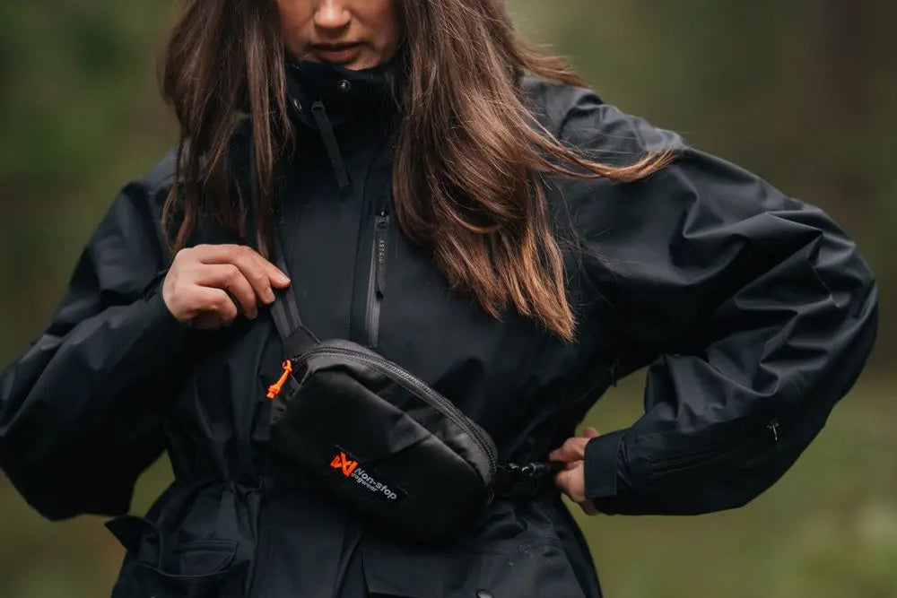 A lady wearing the Trail Quest Storage Pack, with a black coat.