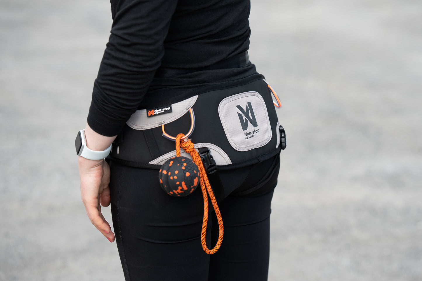 The Explore Belt in use, showing the Non-stop logo & with a ball toy attached to the belt.