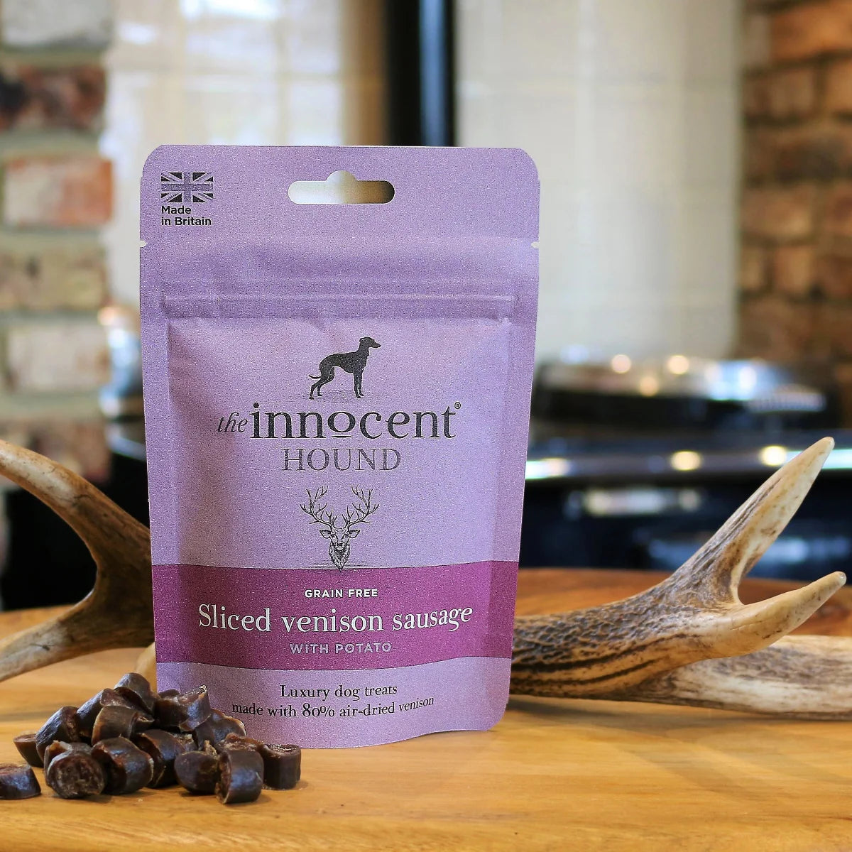 The Innocent Hound Sliced Venison Sausage on a wooden surface with antlers.