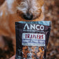 Dog treats package with a dog sniffing the packet.