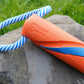 The Bumper Tug positioned on a rock. Orange and blue design, with a rope detail.