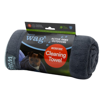 Stock image of the Henry Wag Microfibre Towel, rolled up with packaging around it. The packaging shows a puppy being dried.