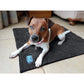 A brown and white dog laying on the Henry Wag Microfibre Noodle Pet Mat, in an indoor setting.