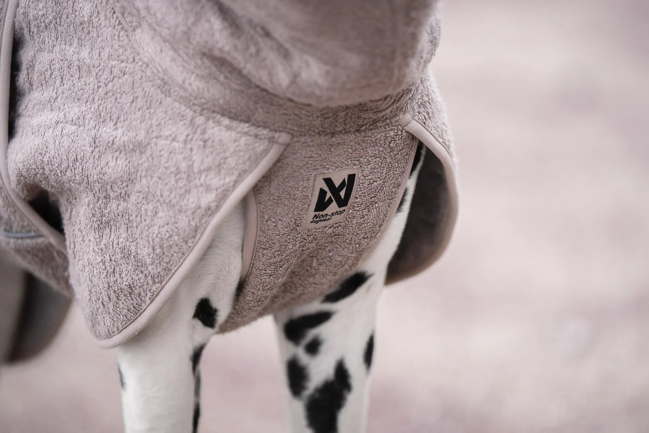 Lifestyle image of the Drying Robe, showing the front panel and the Non-stop dogwear branding.