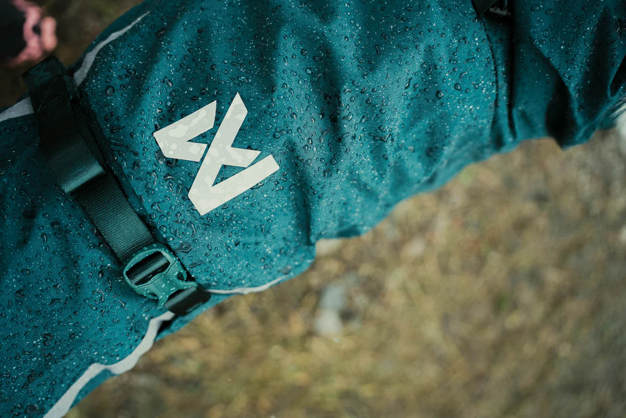 Lifestyle image of the Fjord Lined Jacket, with water beads along the jacket with Non-stop branding.