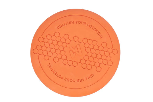 Orange Flying Disc, with hexagonal pattern and Non-stop dogwear Logo on a white background.