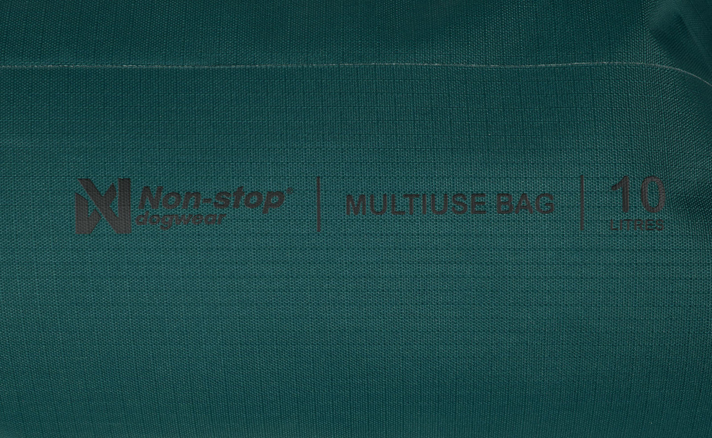 Stitched details of the Multiuse Bag, showing the Non-stop branding and size of the bag.