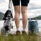 Dog sitting beside their owner and a Multiuse Bag, looking into the horizon.