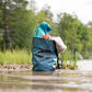The Multiuse Bag carrying towels and toys, in a river environment.