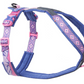 Stock image of the Rachel Pohl Harness, in pink and purple with mountain details, against a white background.