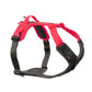 Stock image of the Ramble Harness, a pink and black harness with a handle, on a white background.