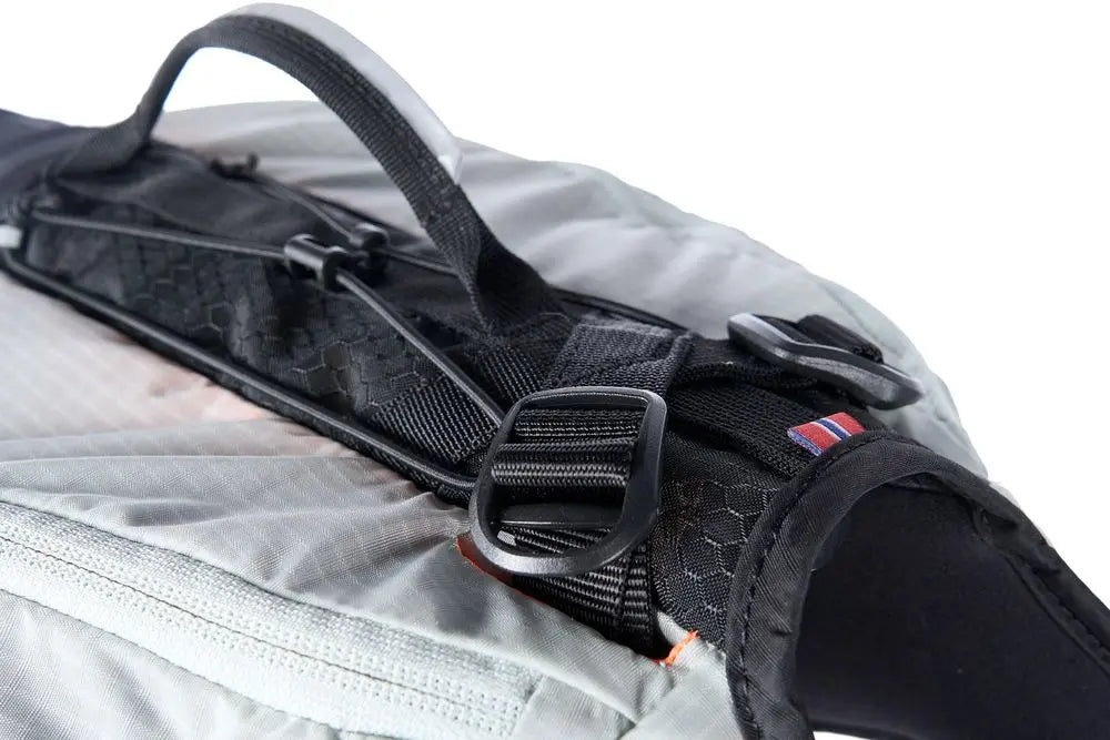 Detailed image of the Trail Light Backpack, a grey backpack with a handle.
