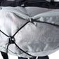 Detailed image of the Trail Light Backpack, a grey backpack with Non-stop branding along the side.