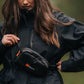 A lady wearing the Trail Quest Storage Pack, with a black coat.