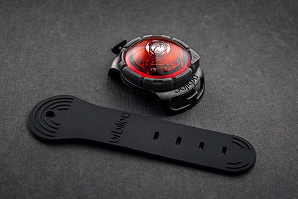 Stock image of the Orbiloc Red Light, against a grey background.