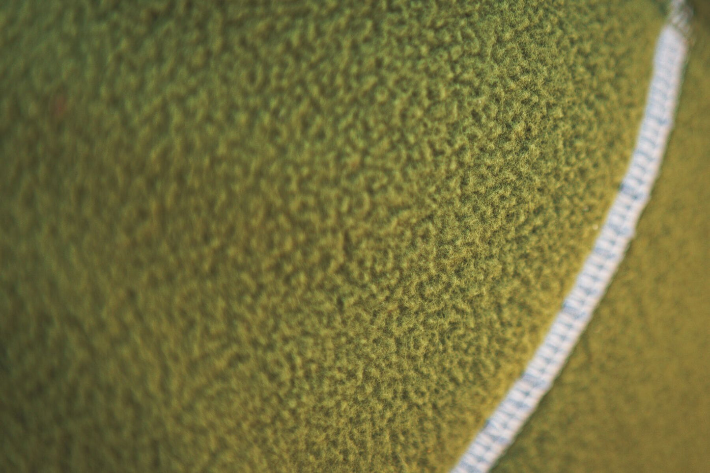 Lifestyle image of the Climate Changer Fleece Vest in Cedar Green, showing a close up of the fleece.