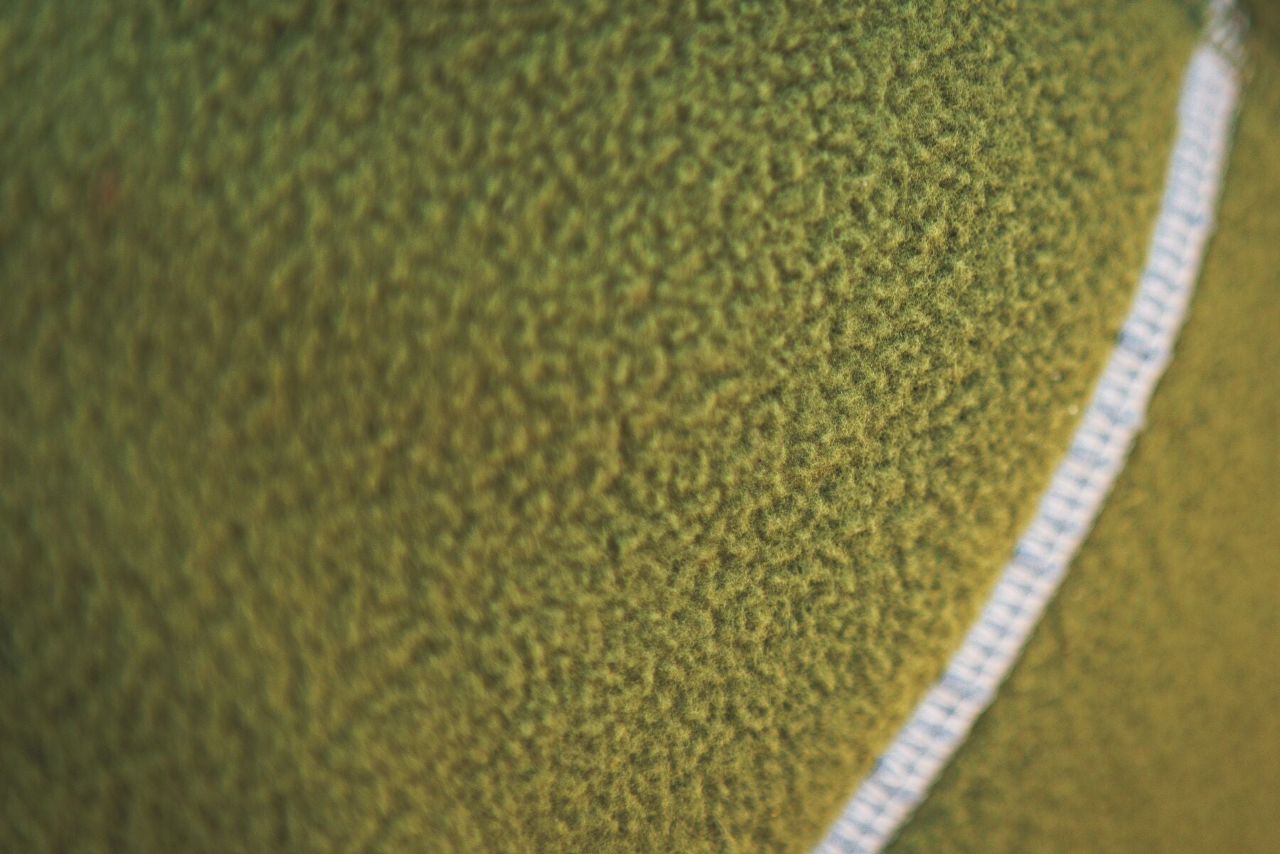 Lifestyle image of the Climate Changer Fleece Vest in Cedar Green, showing a close up of the fleece.