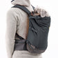 Stock image of the Hitch Hiker Carrier in Basalt Grey, being worn on the back of someone, on a white background.