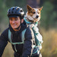 Lifestyle image of the Hitch Hiker Carrier, showing a dog on the back of someone riding a bicycle.