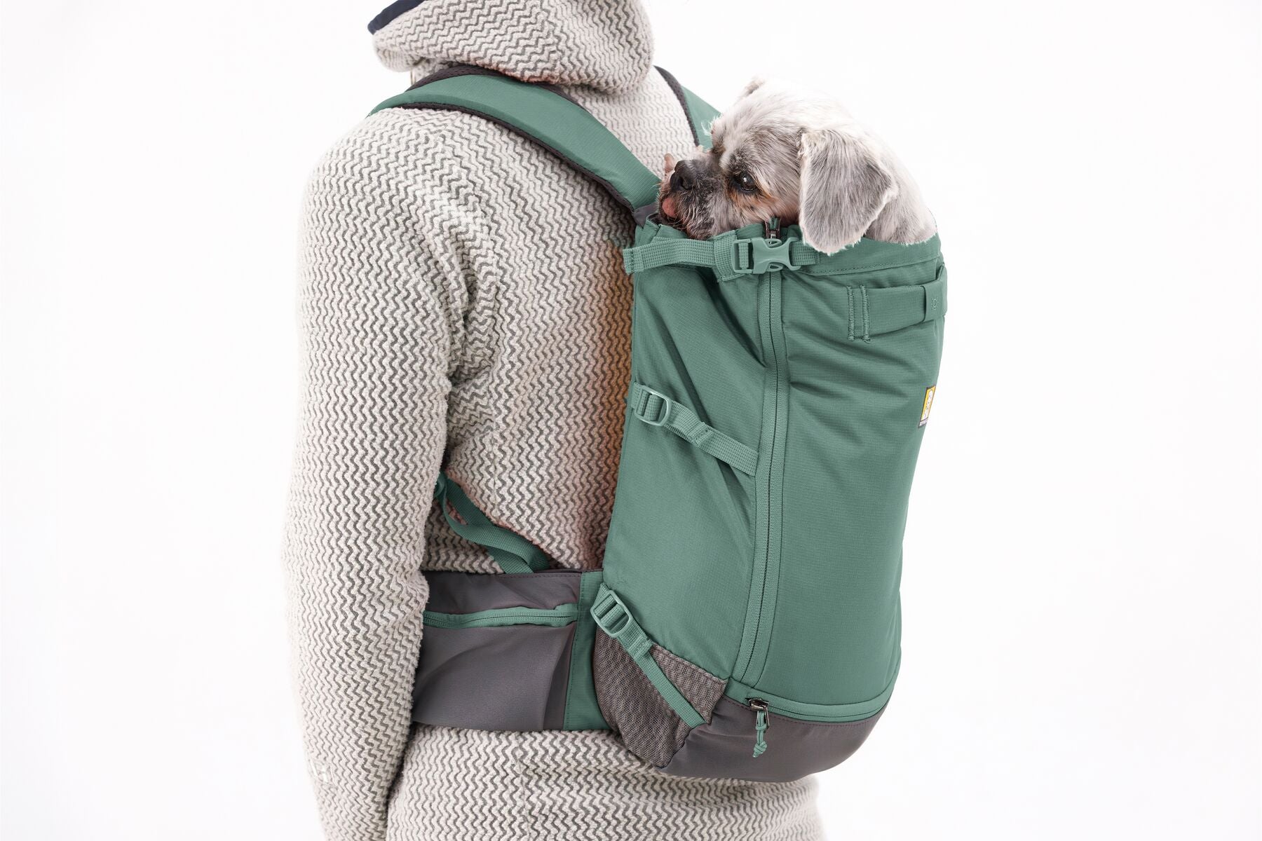 Stock image of the Hitch Hiker Carrier in River Rock Green, being worn on the back of someone, on a white background.