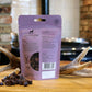 The back of the Innocent Hound Sliced Venison Sausage on a wooden surface with antlers.