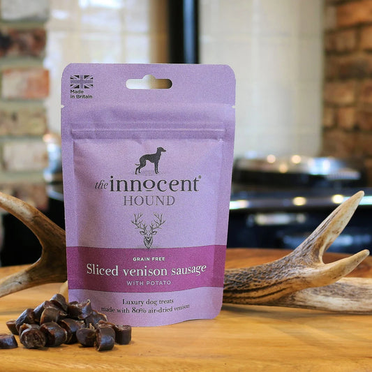 The Innocent Hound Sliced Venison Sausage on a wooden surface with antlers.
