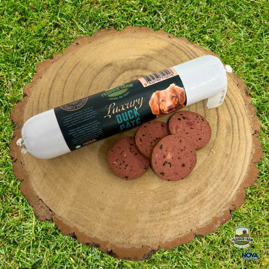 Nova Duck Pate on a log, with some cut slices.