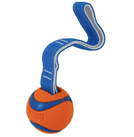 A stock image of the Chuckit! Ultra Tug - an orange ChuckIt! ball with a strap attached.