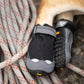 Lifestyle image of the Grip Trex Dog Boots, wearing a pair of Grip Trex boots while a dog lays on some rope.