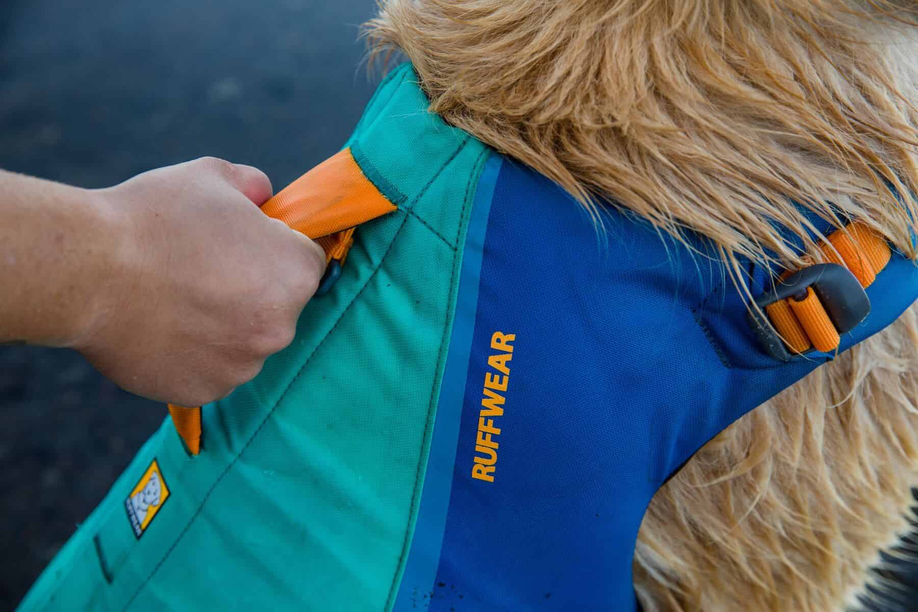 Owner holding the restraint handle of the Float Coat Lifejacket.